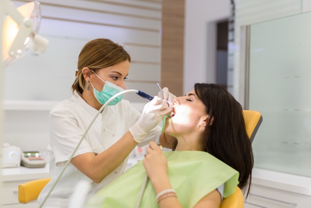 Woman repairing teeth at the dentist office